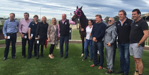 DOWNLOADINGTrainer Rob Heathcote and connections celebrate at Doomben